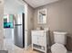 Bathroom with a toilet, sink and vanity in the foreground and a refrigerator in the background at 927 Dean Patrick Rd, Locust Grove, GA 30248