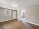 Bedroom with a white door, neutral walls, and large window with a view of trees at 927 Dean Patrick Rd, Locust Grove, GA 30248