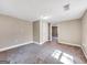 Spacious bedroom with neutral walls, carpet flooring, and a door leading to another room at 927 Dean Patrick Rd, Locust Grove, GA 30248