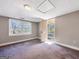 Bedroom with neutral paint, carpeted floor, and a window overlooking the backyard, plus an exit door at 927 Dean Patrick Rd, Locust Grove, GA 30248