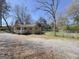 View of home's front exterior, including porch, fence, and gravel surrounding property at 927 Dean Patrick Rd, Locust Grove, GA 30248