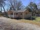 View of home's front exterior, including porch, and fence, providing curb appeal at 927 Dean Patrick Rd, Locust Grove, GA 30248