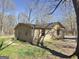 Side view of home with fenced yard and mature trees at 927 Dean Patrick Rd, Locust Grove, GA 30248