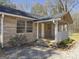Charming front porch featuring brick accents and ample space for relaxing outdoors at 927 Dean Patrick Rd, Locust Grove, GA 30248