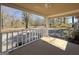 Covered front porch overlooking a spacious, tree-filled yard at 927 Dean Patrick Rd, Locust Grove, GA 30248