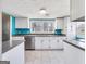 Bright kitchen with white cabinets, blue accent wall and stainless steel appliances at 927 Dean Patrick Rd, Locust Grove, GA 30248