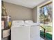Laundry machines featuring a newer water heater and access to the outside, with a fenced yard at 927 Dean Patrick Rd, Locust Grove, GA 30248