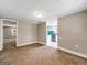 Spacious living room with neutral walls and kitchen view at 927 Dean Patrick Rd, Locust Grove, GA 30248