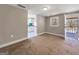 Cozy carpeted living room leading into a bright, white kitchen with blue accent wall at 927 Dean Patrick Rd, Locust Grove, GA 30248