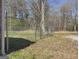 Side yard featuring a chain link fence and grassy area at 927 Dean Patrick Rd, Locust Grove, GA 30248