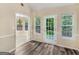 Bright breakfast nook with wood-look floors, multiple windows, and views to the next room with a chandelier at 124 Williams Blf, Mcdonough, GA 30252