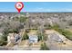 The aerial view of a property outlined, showing location, surrounding trees, and nearby neighborhood at 76 College St, Mcdonough, GA 30253