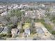 A stunning aerial view of a neighborhood showcasing mature trees, multiple homes, and neighborhood streets at 76 College St, Mcdonough, GA 30253