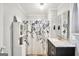 Charming bathroom featuring a dark vanity with a marble top and a shower with a floral curtain at 76 College St, Mcdonough, GA 30253
