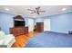 Cozy bedroom with a ceiling fan, wood floors, and blue walls at 76 College St, Mcdonough, GA 30253