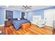 Bedroom featuring blue walls, wood floors, a fireplace, and plenty of natural light at 76 College St, Mcdonough, GA 30253