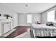 Bright bedroom with wood floors, a fireplace, and neutral decor at 76 College St, Mcdonough, GA 30253