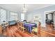 Bright dining room with wood floors, table, chairs, fireplace, and view into living room at 76 College St, Mcdonough, GA 30253