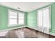 Empty room with hardwood floors, bright green walls and lots of natural light at 76 College St, Mcdonough, GA 30253