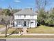 Classic two-story home with a welcoming front porch, complemented by a well-manicured lawn and mature trees at 76 College St, Mcdonough, GA 30253
