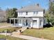 Inviting two-story home with a classic front porch, set on a well-maintained lawn and landscaped grounds at 76 College St, Mcdonough, GA 30253