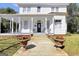 Charming two-story home with a welcoming front porch, enhanced by decorative planters and a well-kept yard at 76 College St, Mcdonough, GA 30253