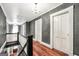 Upstairs hallway with hardwood floors, gray walls, white trim, and decorative chandelier at 76 College St, Mcdonough, GA 30253