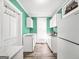 Narrow but functional kitchen featuring white cabinets, gas range, and bright natural light at 76 College St, Mcdonough, GA 30253