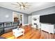 Cozy living room boasting hardwood floors, a decorative fireplace, and comfortable seating with modern features at 76 College St, Mcdonough, GA 30253