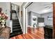 Elegant living room featuring hardwood floors, a cozy fireplace, and stylish decor with stairway at 76 College St, Mcdonough, GA 30253