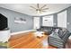 Spacious living room showcasing gleaming hardwood floors, ample natural light, and contemporary furnishings at 76 College St, Mcdonough, GA 30253