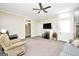 Bright living room featuring plush carpeting, ceiling fan, and classic fireplace at 76 College St, Mcdonough, GA 30253