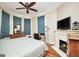 Spacious bedroom featuring a fireplace, TV, and dresser under the window at 76 College St, Mcdonough, GA 30253