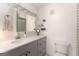 Bathroom with a modern vanity, a mirror with lighting, and a white toilet at 3529 Essex Ave # 75, Atlanta, GA 30339