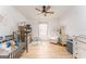 Bright Bedroom with hardwood floors, crib, and white furniture at 3529 Essex Ave # 75, Atlanta, GA 30339