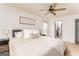 Bright bedroom featuring a ceiling fan, a cozy bed with throw pillows, and an ensuite closet at 3529 Essex Ave # 75, Atlanta, GA 30339