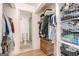 Well-organized walk-in closet leading to a tiled bathroom with storage at 3529 Essex Ave # 75, Atlanta, GA 30339