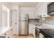 Bright kitchen with stainless steel appliances, white cabinets, and hexagon tile backsplash at 3529 Essex Ave # 75, Atlanta, GA 30339