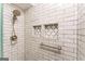 Updated shower with designer tile, a shower head, and recessed shelving for storage at 3529 Essex Ave # 75, Atlanta, GA 30339