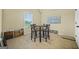 A dining area with neutral carpeting and a dark wood table at 2377 Aukerman Trce # 82, Hampton, GA 30228