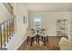 Cozy dining area with a table and chairs next to the stairway and a bright window at 2377 Aukerman Trce # 82, Hampton, GA 30228