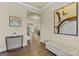 Inviting foyer featuring wood-look floors, neutral walls, and a decorative console table, creating a warm ambiance at 2377 Aukerman Trce # 82, Hampton, GA 30228