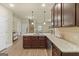 Spacious kitchen featuring granite counters, dark wood cabinets, and modern stainless-steel appliances at 2377 Aukerman Trce # 82, Hampton, GA 30228