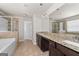Bathroom featuring double vanity, granite countertops, tub, and separate glass shower at 7754 Hansel Ln, Lithonia, GA 30058