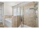 Bathroom featuring tiled shower, tub, and a window providing natural light at 7754 Hansel Ln, Lithonia, GA 30058