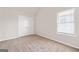 Bedroom features double door closet, neutral paint, and lots of natural light at 7754 Hansel Ln, Lithonia, GA 30058