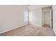 Empty bedroom with neutral carpet and paint provides a calming atmosphere at 7754 Hansel Ln, Lithonia, GA 30058