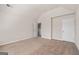 Empty bedroom with neutral walls and plush carpet offers a flexible space at 7754 Hansel Ln, Lithonia, GA 30058