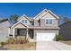 Charming two-story home with attached two car garage, beautiful landscaping and covered front porch at 7754 Hansel Ln, Lithonia, GA 30058