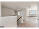Upstairs hallway with neutral walls and carpeted floor leads to bedrooms and bathrooms at 7754 Hansel Ln, Lithonia, GA 30058